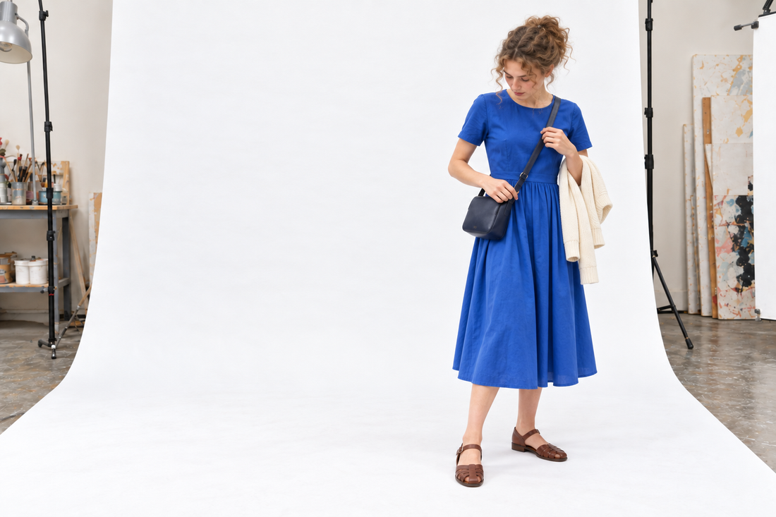 Cobalt cotton dress with brown flats, a dark crossbody bag and a cream cardigan