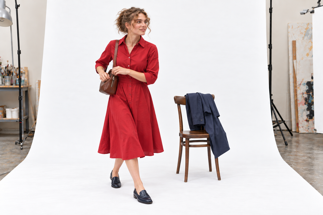 Red midi dress with navy flats, a compact brown shoulder bag and a light navy coat for Festival of Speed hospitality.