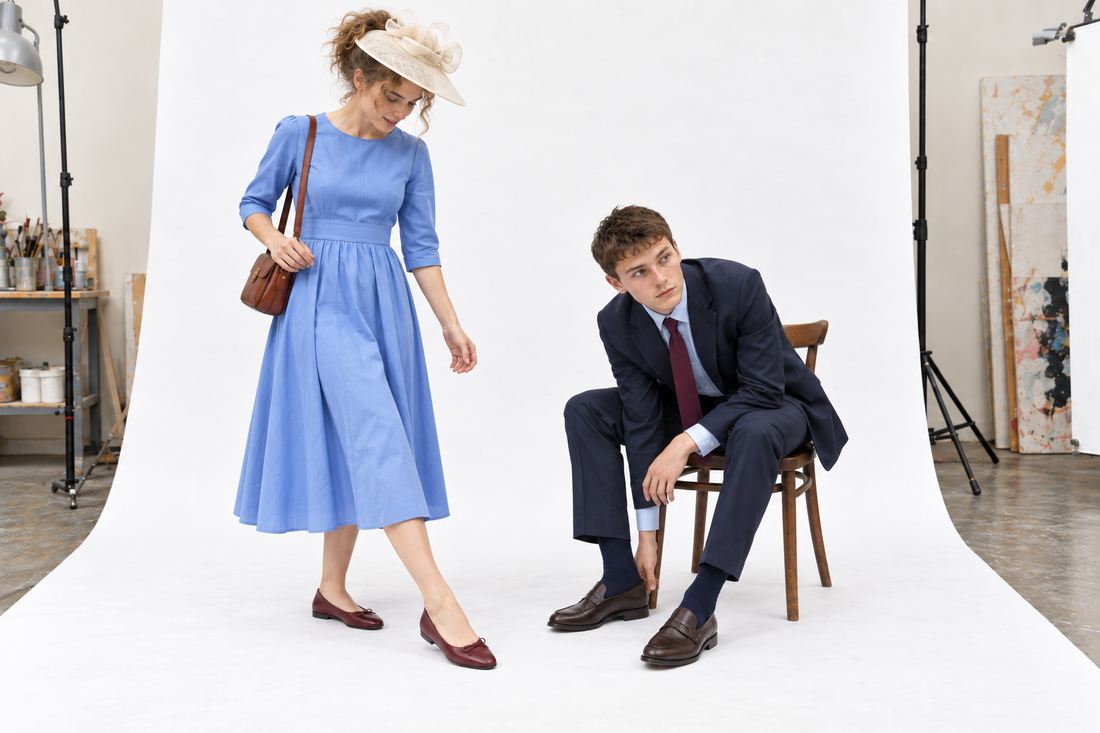 Woman testing burgundy flats with a cornflower blue dress while a man in a navy suit checks brown loafers and ankle-covering socks.